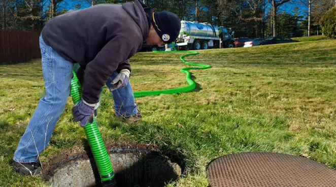Service technician performing residential septic pumping and drainage maintenance in Ann Arbor, MI